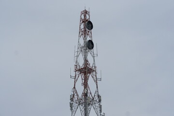 telephone transmission tower There is a signal dish on the pole.