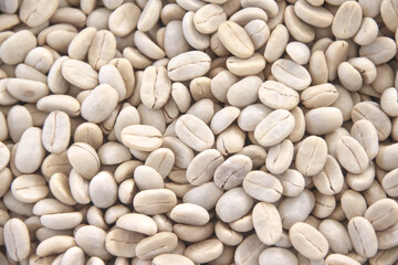 Raw coffee beans pile background