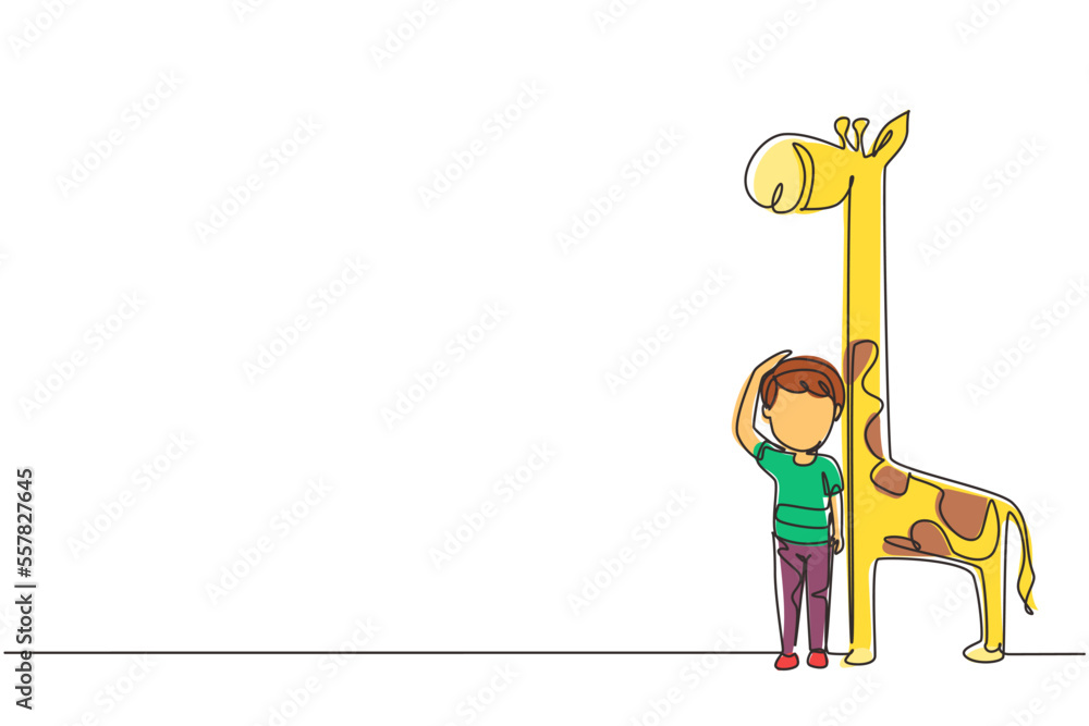 Poster single continuous line drawing little boy measuring his height with giraffe height chart on wall. ki