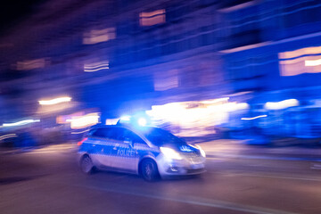 Patrol car of the Berlin police drives with blue lights to a mission through Oderberger Straße in...