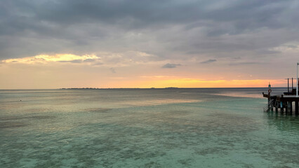 Fototapeta na wymiar Beautiful Tropical sunset landscape in Maldives island Baa , with infinity Indian ocean sea water view and cloudy skies , perfect relaxing Honeymoon travel destination 