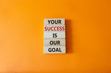 Your success is our goal symbol. Wooden blocks with words Your success is our goal. Beautiful orange background. Business and Your success is our goal concept. Copy space
