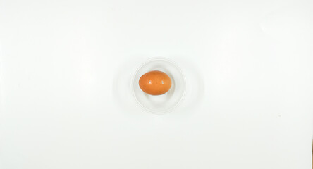 Top view of eggs in clear bowl on white background, isolated
