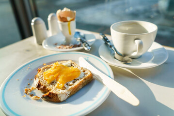 Toasted bread with butter and hot coffee.