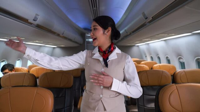 Flight Attendant Performing A Pre-flight Safety Demonstration. Cabin Crew Or Air Hostess Occupation Working In Airplane . Concept Of Emergency Checklists, Airline, Customer Service And Passenger.