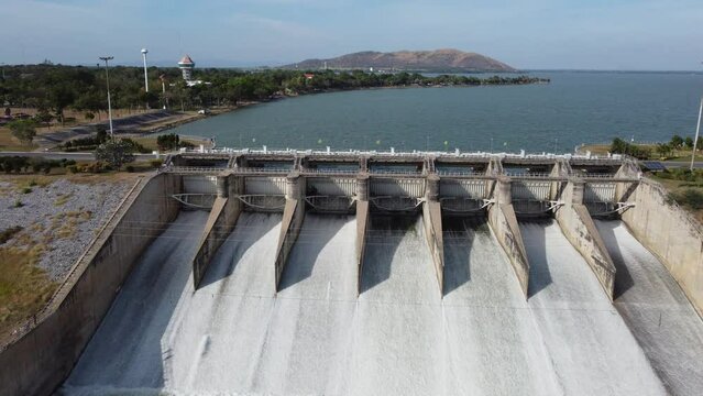 An aerial view over the Pasak Jolasid dam, Lopburi Province, Thailand. Tracking the movement of the floodgates that are releasing water into rural canals in enormous amounts of water.