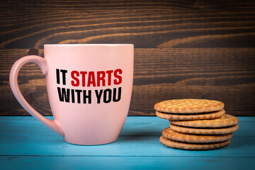 It Starts With You. Text on a coffee mug