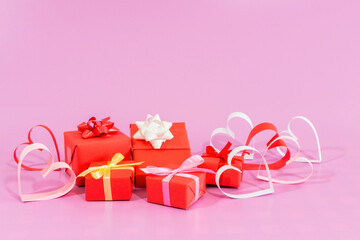 Paper Love hearts and gifts on pink background.