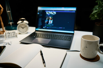 Workplace at home office with laptop, cup of coffee and lamp on desk for working at night