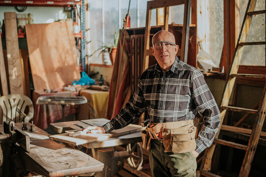 Senior craftsman looking at camera in workshop