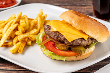 Cheeseburger with Tomatoes and Pickles with French Fries and Ketchup