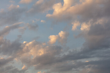 Naklejka na ściany i meble Colorful clouds at sunset as background.