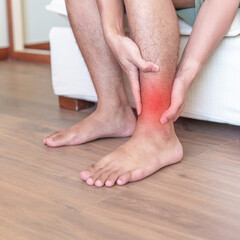 Man having leg pain due to Ankle Sprains or Achilles Tendonitis and Shin Splints ache. injuries,...