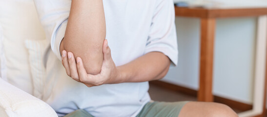 Man having elbow ache and muscle pain due to lateral epicondylitis or tennis elbow. injuries and...