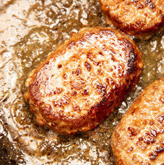 Cutlets are fried in oil in a frying pan.
