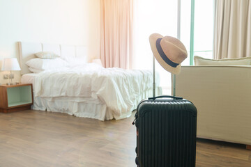 Black Luggage with hat in modern hotel room after door opening. Baggage for Time to travel,...