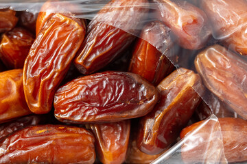 Dried dates in a package as a background.
