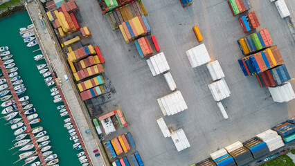 Obraz premium Aerial image of logistics platform with containers to import and export materials by ship 