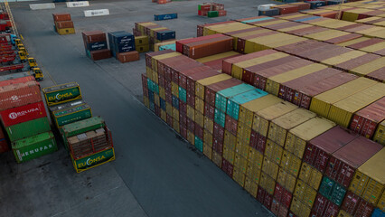 Fototapeta premium Aerial image of logistics platform with containers to import and export materials by ship 