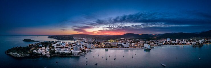 Spain, Balearic Islands, Santa Ponsa, Mallorca, Aerial panorama of seaside town at dusk