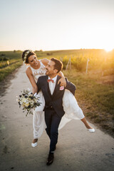 Wedding in the vineyards, bride and groom in the sunset
