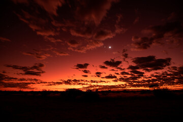 Clouds floating over savannah at fiery dawn