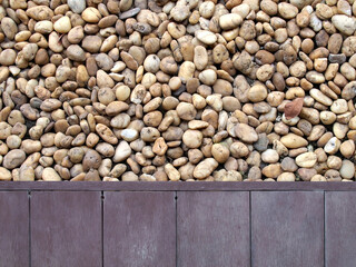 edge of rustic purple wooden patio floor and brown beige pebble stone ground, lliving terrace and zen style rock garden, home relaxing corner, close up top view with copy space