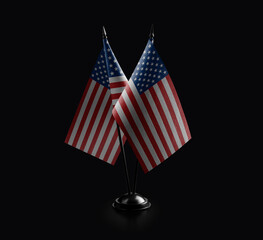 Small national flags of the USA on a black background