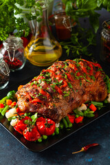 Whole roasted, stuffed with tomatoes and olives, pork neck.