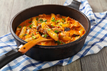 Traditional Korean Tteokbokki rice noodles with chicken, vegetables and shitake mushrooms. Prepared in a pan.