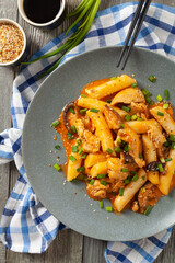 Traditional Korean Tteokbokki rice noodles with chicken, vegetables and shitake mushrooms. Prepared in a pan.
