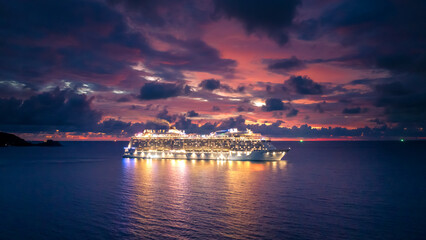 Fototapeta na wymiar Cruise ship at sea aerial view with dramatic clouds at sunset in the Andaman Sea, Phuket, Thailand