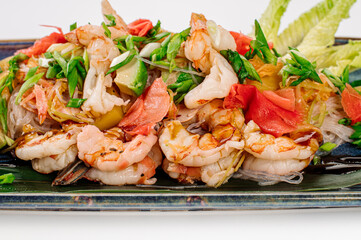 Dish of glass noodles with srimps and vegetables on grey background. Wok menu