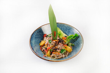 Meat salad with noodles and vegetables on grey background. Wok menu