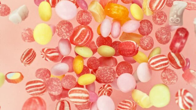 Super slow motion of flying candies up in the air. Camera in super fast motion. Filmed on high speed cinema camera, 1000 fps, placed on high speed cine bot.