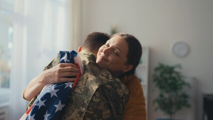 Happy American wife embracing soldier husband coming back home, family reunion