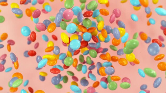 Super slow motion of flying candies up in the air. Camera in super fast motion. Filmed on high speed cinema camera, 1000 fps, placed on high speed cine bot. Speed ramp effect.