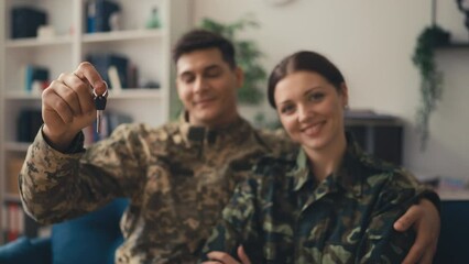 Happy service member family showing keys from new flat, home grants and loans