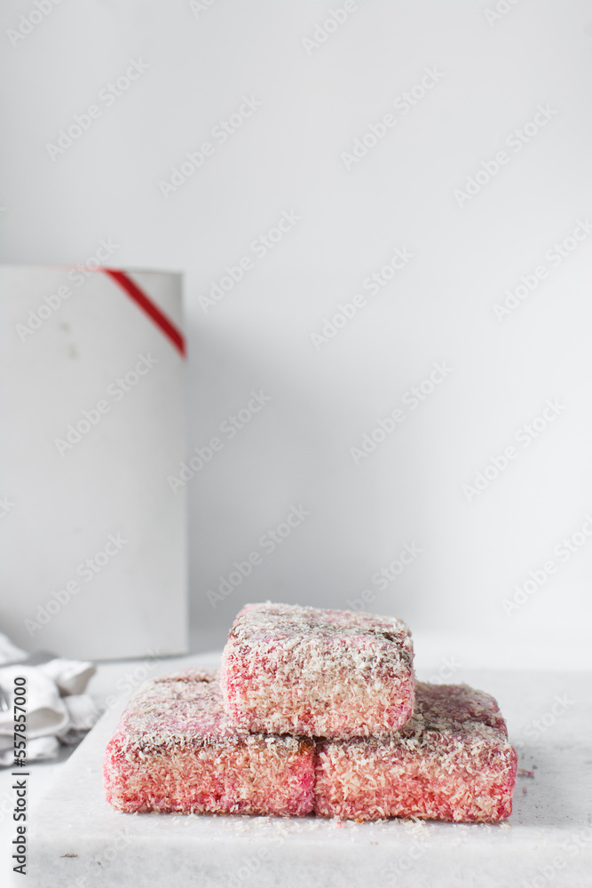 Canvas Prints Pink lamingtons on a marble tray, Australian raspberry lamingtons, cake covered in desiccated coconuts