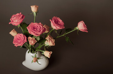 Beautiful bouquet of roses on a brown and gray background for congratulations