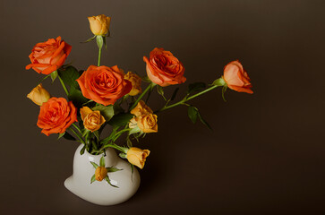 Beautiful bouquet of roses on a brown and gray background for congratulations
