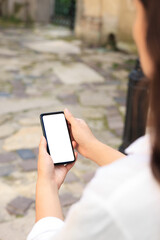 Closeup view of woman using smartphone outdoors