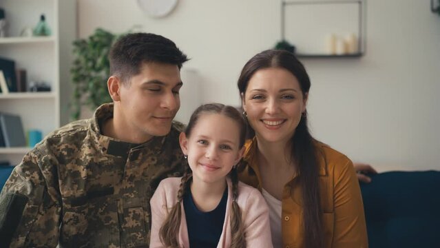 Portrait of young soldier with his wife and daughter, happy family, true love