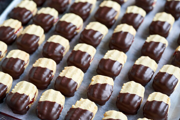 Handmade Christmas cookies filled with marmalade and dipped in chocolate