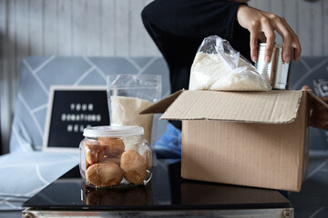 Hand of woman preparing staple food for donation and charity event. 