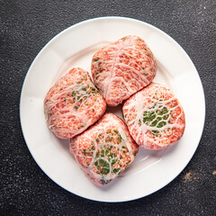 cutlet ground meat in fat grid fatty mesh pork, beef raw minced meat fresh meal snack on the table copy space food background rustic top view