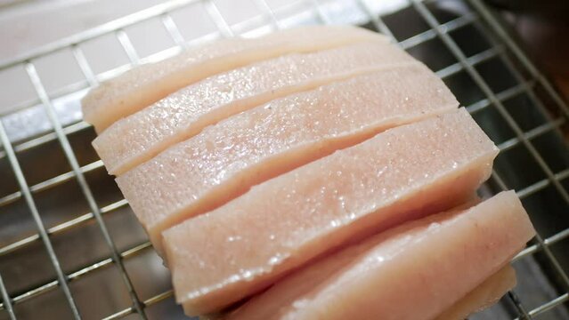 close up view to raw boild crispy pork while place to dry and preparing to fried