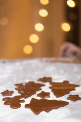 Cooking Christmas gingerbread cookies on a white background. Vertical photo.