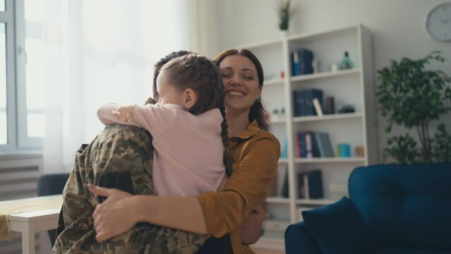 Happy young soldier father returning to his family, service member at home