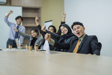 Group of executive worker are fist hands up together to celebrating achievement as successful business team at the office.